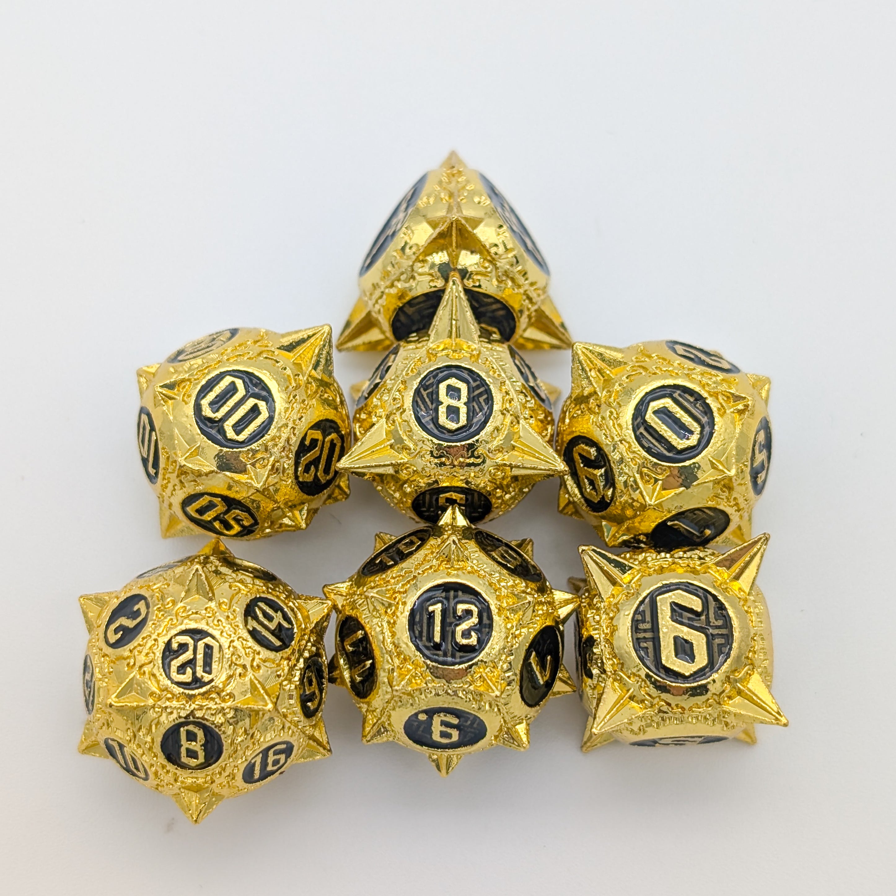 Caltrops Gold and Black Metal Core Dice Set