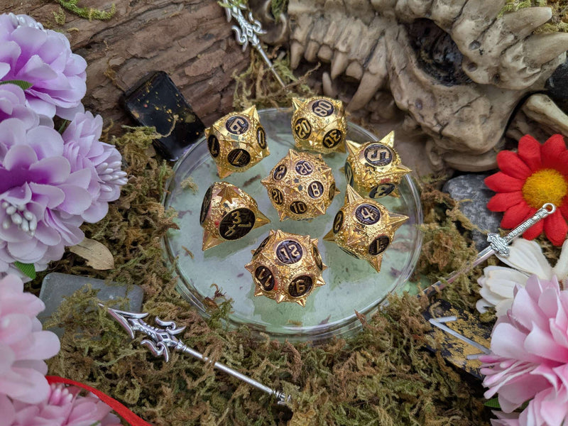 Caltrops Gold and Black Metal Core Dice Set
