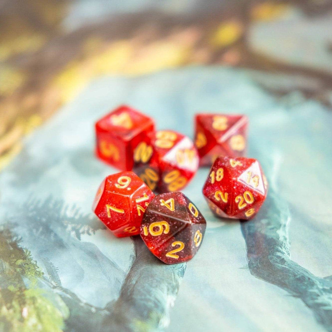  Sparkle Red Dice Set laying on a dnd table - Mystery Dice Goblin