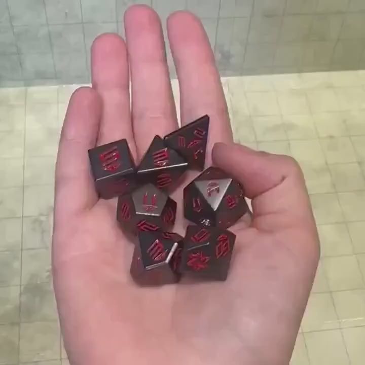 Metal Black and Red Dnd Dice Set beinbg rolled 