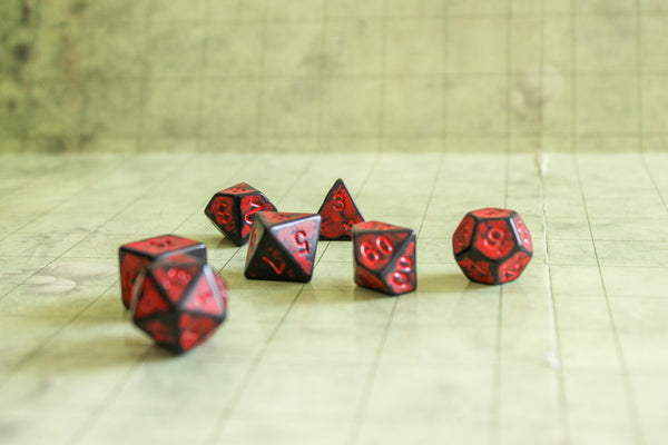 red and black dice on a dnd table - Mystery Dice Goblin