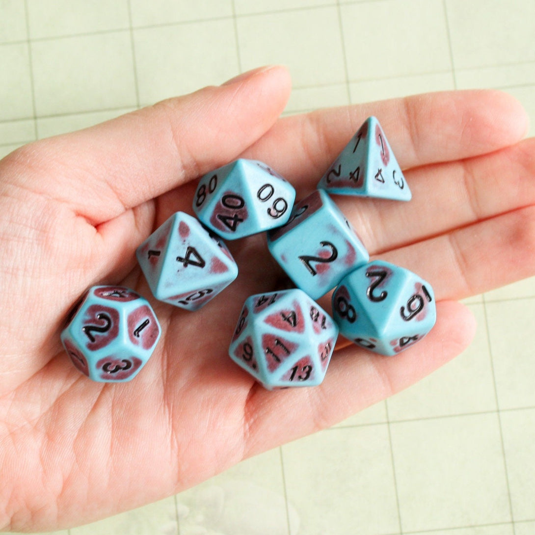 polyhedral dice in the hand of a player - MysteryDiceGoblins